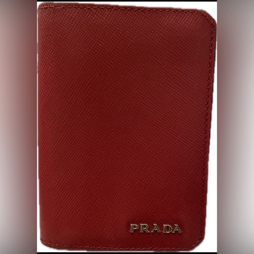 Prada, small, red wallet. The wallet allows for several cards and cash.
